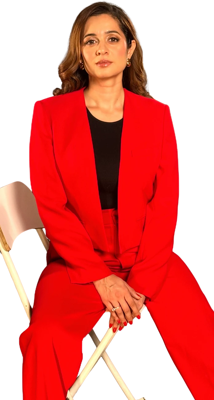 Mansha Arora, life coach, wearing a red suit